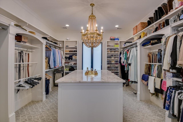 spacious closet featuring light carpet, visible vents, and a notable chandelier