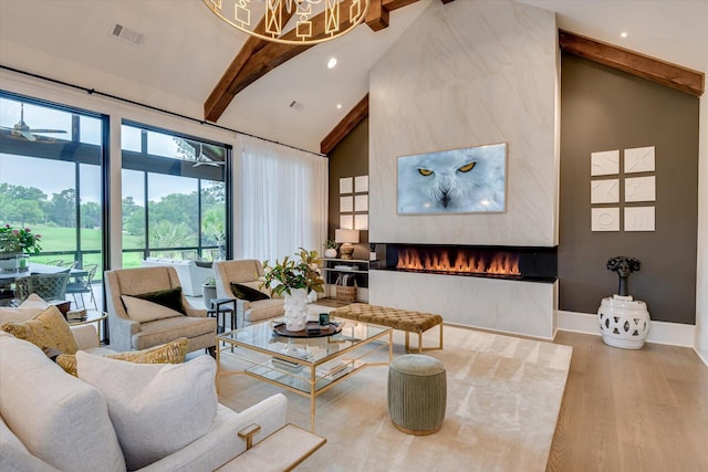 living area featuring high vaulted ceiling, a fireplace, wood finished floors, visible vents, and beam ceiling