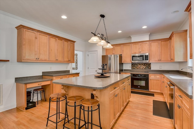 920 Napiers Post Dr, Evans, GA 30809 - kitchen featuring appliances with stainless steel finishes, a kitchen breakfast bar, dark countertops, a center island, and light wood-style floors