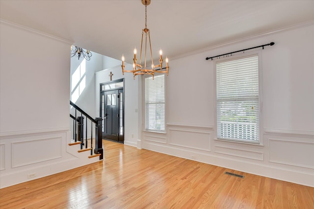 920 Napiers Post Dr, Evans, GA 30809 - foyer with a chandelier, healthy amount of natural light, wood finished floors, ornamental molding, and a wainscoted wall