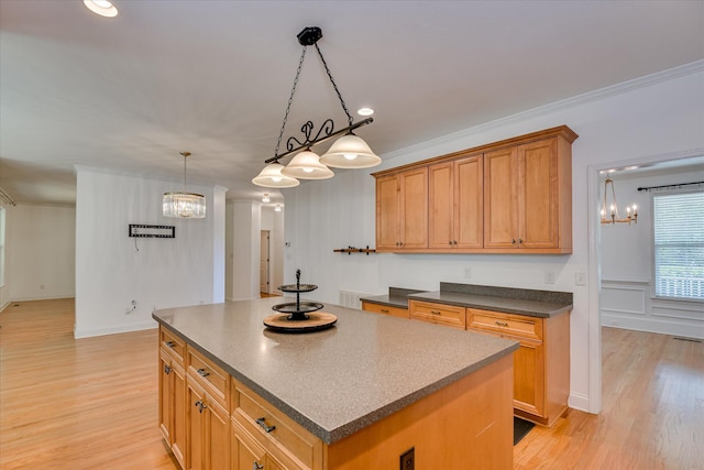 920 Napiers Post Dr, Evans, GA 30809 - kitchen with a kitchen island, dark countertops, light wood finished floors, a chandelier, and crown molding
