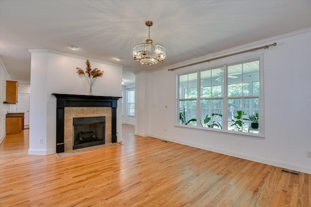 920 Napiers Post Dr, Evans, GA 30809 - unfurnished living room with ornamental molding, light wood-style floors, a chandelier, and a tile fireplace