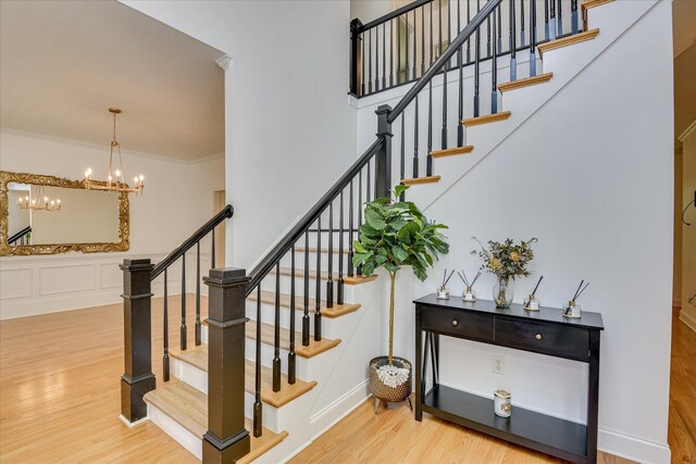 920 Napiers Post Dr, Evans, GA 30809 - stairway with wood finished floors, a chandelier, and crown molding