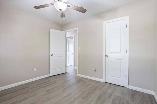 305 Manchester Ct, Grovetown, GA 30813 - unfurnished bedroom with light wood-style flooring, baseboards, and ceiling fan