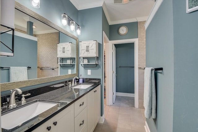 bathroom featuring tile patterned flooring, ornamental molding, and a sink