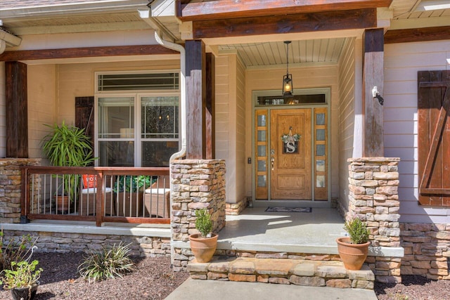 entrance to property with stone siding and covered porch