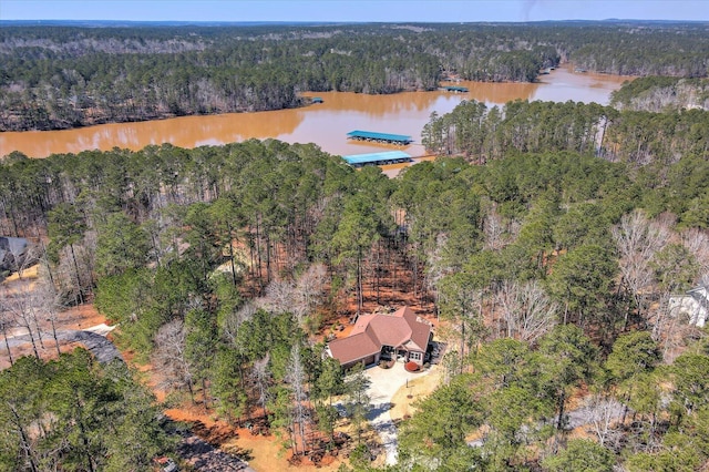 bird's eye view featuring a wooded view and a water view