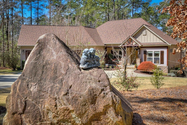 craftsman inspired home featuring board and batten siding and roof with shingles