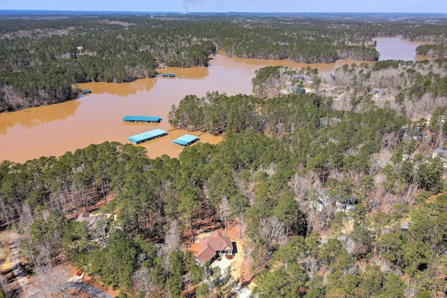 aerial view with a forest view and a water view