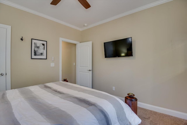 carpeted bedroom featuring baseboards, ornamental molding, and a ceiling fan