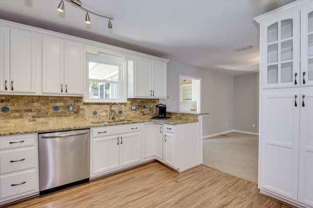 307 Candlewood Dr, Martinez, GA 30907 - kitchen with stainless steel dishwasher, a sink, a peninsula, white cabinets, and backsplash