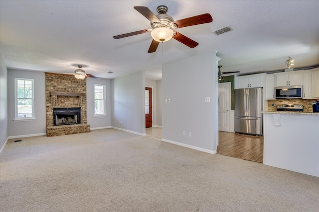 307 Candlewood Dr, Martinez, GA 30907 - unfurnished living room with light carpet, ceiling fan, plenty of natural light, and baseboards
