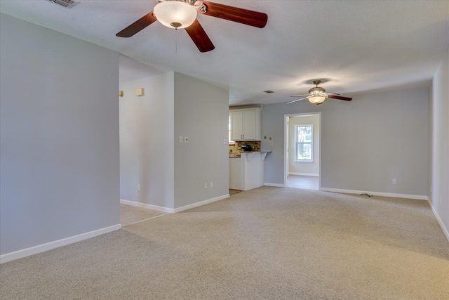307 Candlewood Dr, Martinez, GA 30907 - unfurnished living room with a ceiling fan, light colored carpet, and baseboards