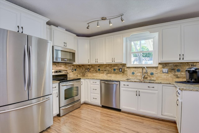 307 Candlewood Dr, Martinez, GA 30907 - kitchen featuring stainless steel appliances, a sink, white cabinetry, and tasteful backsplash
