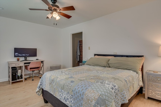 bedroom with light wood-style flooring, ceiling fan, and baseboards