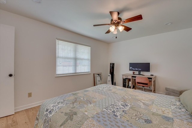 bedroom with light wood-style flooring, baseboards, and ceiling fan