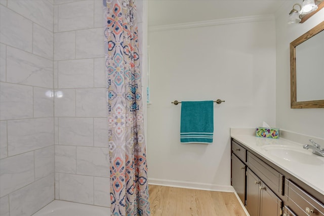 bathroom featuring crown molding, wood finished floors, vanity, shower / bath combination with curtain, and baseboards