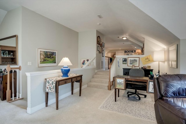 office area featuring lofted ceiling, carpet, and baseboards