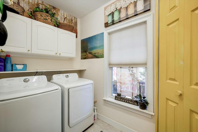 laundry area with washer and dryer, baseboards, cabinet space, and tile patterned floors