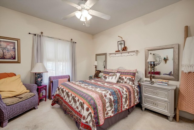 bedroom featuring light carpet and a ceiling fan