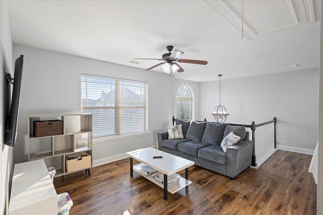 living room featuring ceiling fan with notable chandelier and dark hardwood / wood-style flooring