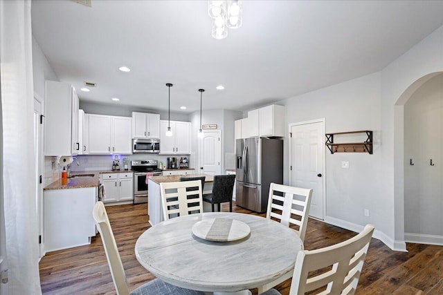 dining room with sink and dark hardwood / wood-style floors