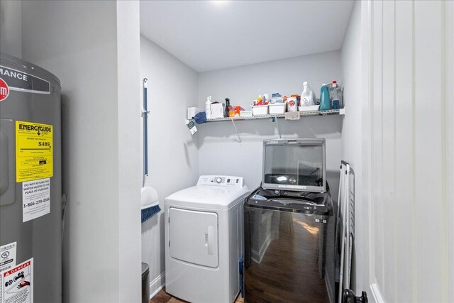 laundry room featuring electric water heater and separate washer and dryer