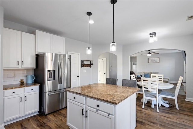 kitchen with decorative backsplash, stainless steel fridge with ice dispenser, white cabinetry, and ceiling fan