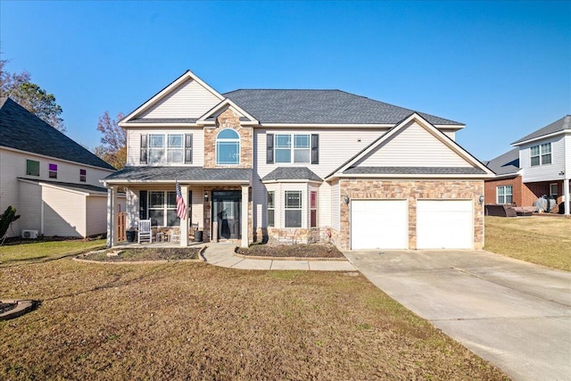 view of front facade featuring a front lawn, covered porch, and a garage