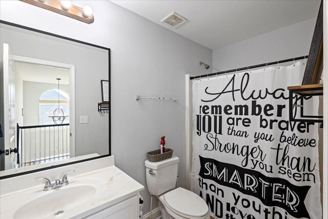 bathroom with vanity, a shower with shower curtain, and toilet