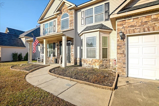 view of front of house featuring covered porch and a garage