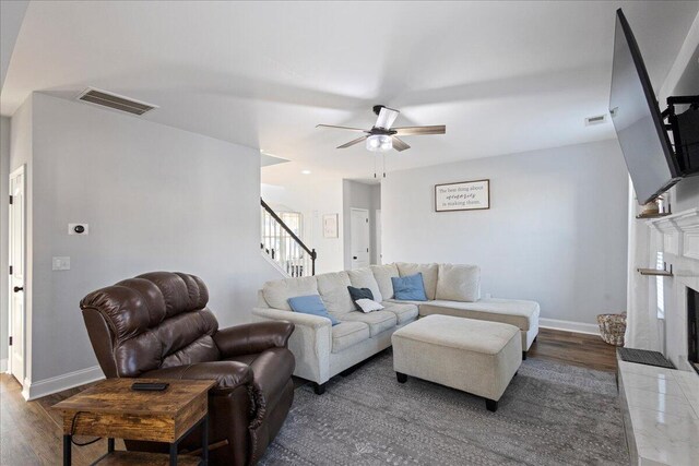 living room featuring dark hardwood / wood-style flooring and ceiling fan