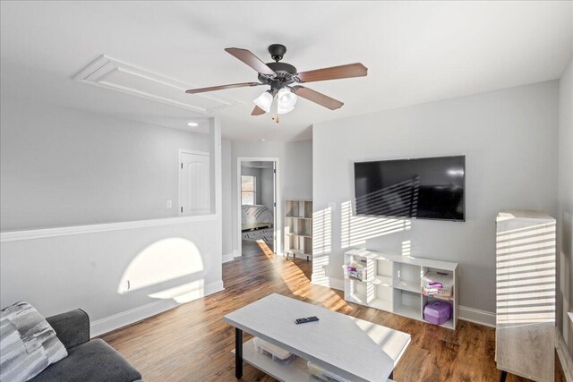 living room featuring wood-type flooring and ceiling fan