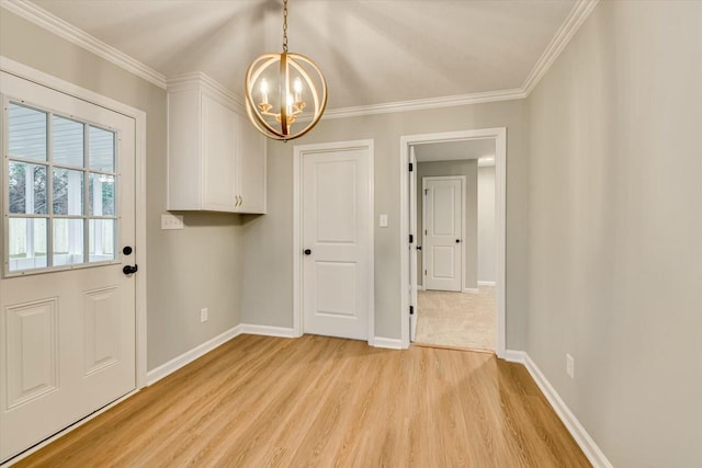 interior space featuring an inviting chandelier, crown molding, and light hardwood / wood-style flooring