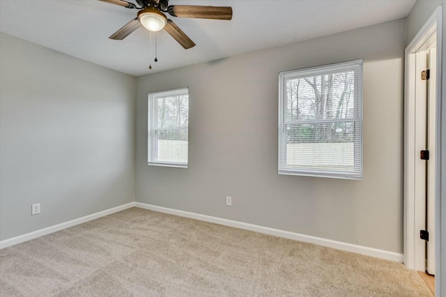 spare room featuring ceiling fan and light colored carpet