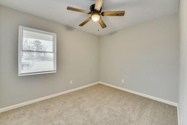 carpeted spare room featuring ceiling fan