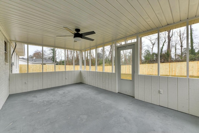 unfurnished sunroom featuring ceiling fan