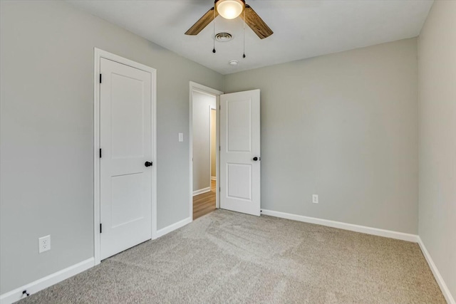 unfurnished bedroom with light carpet and ceiling fan