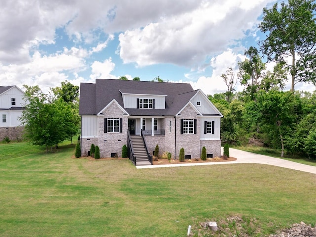 477 Rivernorth Dr, North Augusta, SC 29841 - view of front facade with stairs, brick siding, a front yard, driveway, and board and batten siding