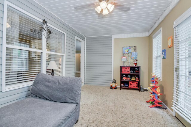 interior space with ceiling fan and carpet floors