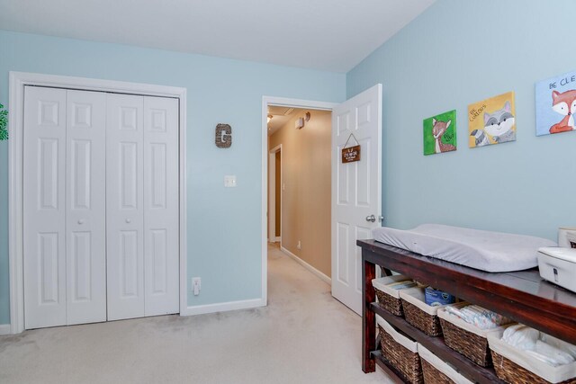 bedroom with a closet and light colored carpet