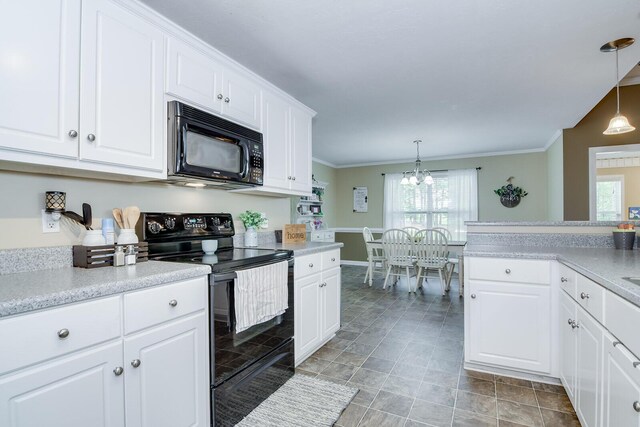 kitchen with black appliances, decorative light fixtures, white cabinets, and an inviting chandelier