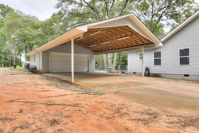 view of parking with a carport and a garage