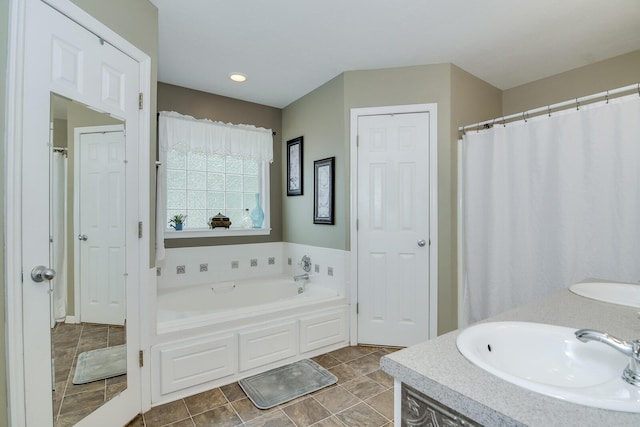 bathroom featuring vanity and a bath