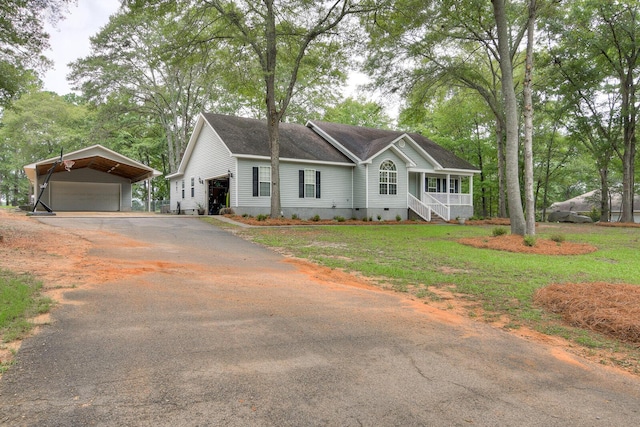 view of front of home featuring a front lawn, a garage, and a carport