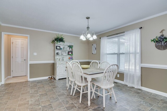 dining space with ornamental molding and a notable chandelier