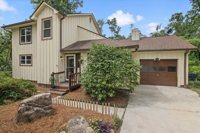 3736 Winchester Trl, Martinez, GA 30907 - view of front of home featuring driveway, board and batten siding, roof with shingles, an attached garage, and a chimney