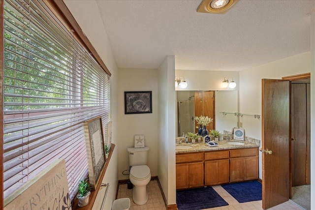 3736 Winchester Trl, Martinez, GA 30907 - bathroom featuring double vanity, a textured ceiling, and a shower