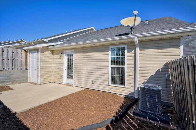 rear view of house with a patio area and cooling unit