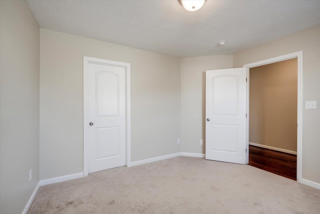 unfurnished bedroom with light colored carpet